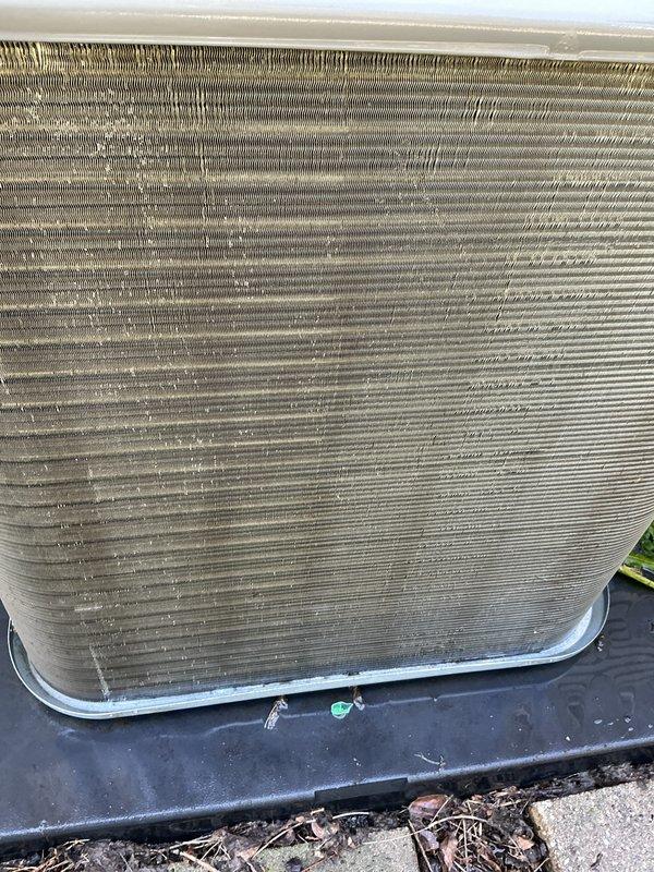 Responded to emergency no-cool call on two-year-old residential AC system. Upon arrival, performed electrical diagnostics on outdoor condensing unit using clamp meter, recording amperage reading of 48.1 amps at the contactor. Inspected condenser coil and found moderate accumulation of dirt, dust, and debris between aluminum fins, which was restricting proper airflow and reducing heat transfer efficiency. Assessed overall unit condition and identified maintenance needs. System restored to proper operation following service procedures.