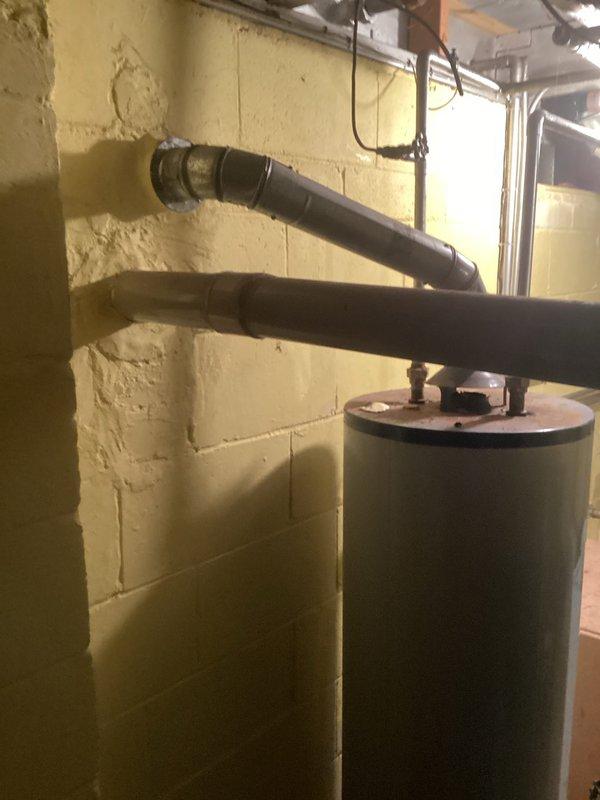 Conducted comprehensive assessment of existing HVAC system located in basement utility area for air conditioning replacement estimate. Evaluated current furnace/air handler unit and associated ductwork configuration to determine compatibility requirements for new AC system installation. Documented existing equipment layout, including proximity to water heater and available clearances for proper airflow and service access. Photographed current system components and mechanical room conditions to support equipment sizing recommendations and identify any necessary modifications to electrical, condensate drainage, or refrigerant line routing for replacement unit installation.