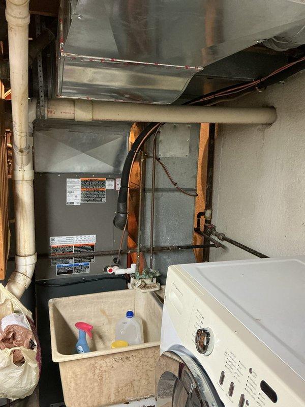 # HVAC System Installation

Successfully completed a full air conditioning system installation in the basement utility area. Installed a new single-stage condenser unit with matching upflow cased coil package, mounted to the existing furnace infrastructure. Ran new refrigerant lineset with proper insulation from the outdoor condenser to the indoor coil, ensuring proper routing along floor joists and through foundation penetrations. 

Installed new concrete equipment pad for outdoor condenser placement and mounted unit with proper clearances. Completed all electrical connections including new disconnect box and whip to meet code requirements. Installed new programmable thermostat and verified proper system communication and operation. All ductwork connections were sealed and secured to the new coil assembly, with sheet metal modifications completed as needed for proper airflow. System was pressure tested for leaks, evacuated to manufacturer specifications, and charged with refrigerant t