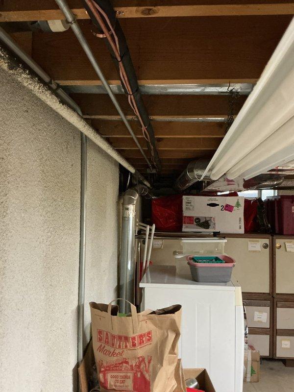 # HVAC System Installation

Successfully completed a full air conditioning system installation in the basement utility area. Installed a new single-stage condenser unit with matching upflow cased coil package, mounted to the existing furnace infrastructure. Ran new refrigerant lineset with proper insulation from the outdoor condenser to the indoor coil, ensuring proper routing along floor joists and through foundation penetrations. 

Installed new concrete equipment pad for outdoor condenser placement and mounted unit with proper clearances. Completed all electrical connections including new disconnect box and whip to meet code requirements. Installed new programmable thermostat and verified proper system communication and operation. All ductwork connections were sealed and secured to the new coil assembly, with sheet metal modifications completed as needed for proper airflow. System was pressure tested for leaks, evacuated to manufacturer specifications, and charged with refrigerant t
