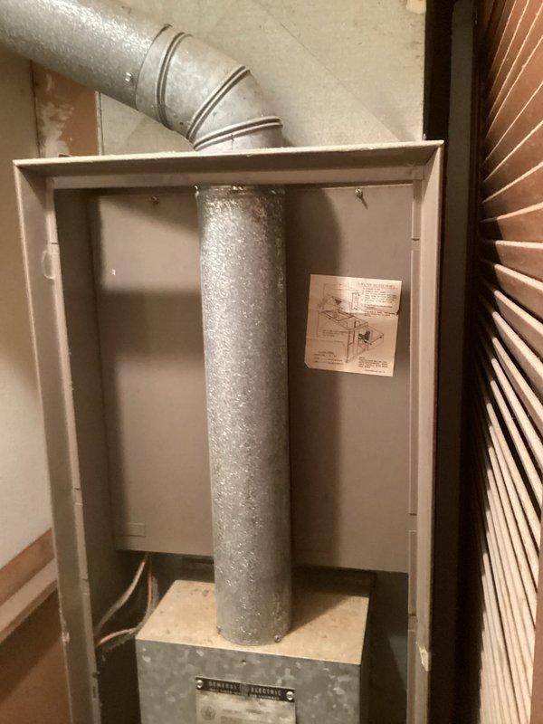 Conducted comprehensive full system replacement estimate for residential HVAC installation. Documented existing indoor furnace unit housed in basement utility area with vertical ductwork configuration and outdoor condenser unit with significant vegetation overgrowth obstructing airflow and access. Photographed current equipment placement, ductwork routing, and site conditions to provide accurate replacement system specifications and installation requirements.