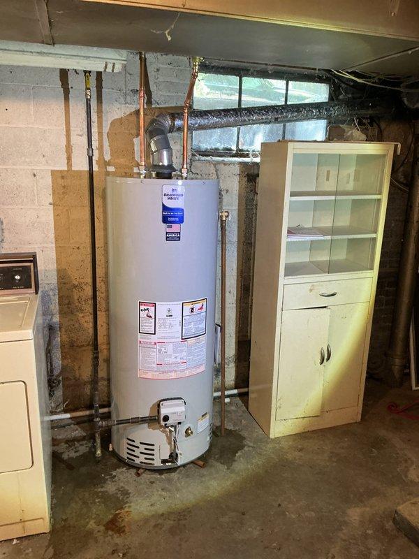 Installed 50-gallon tanked water heater in basement mechanical room. Unit was properly leveled, copper supply lines connected, and all connections verified for secure installation per manufacturer specifications and local plumbing codes.