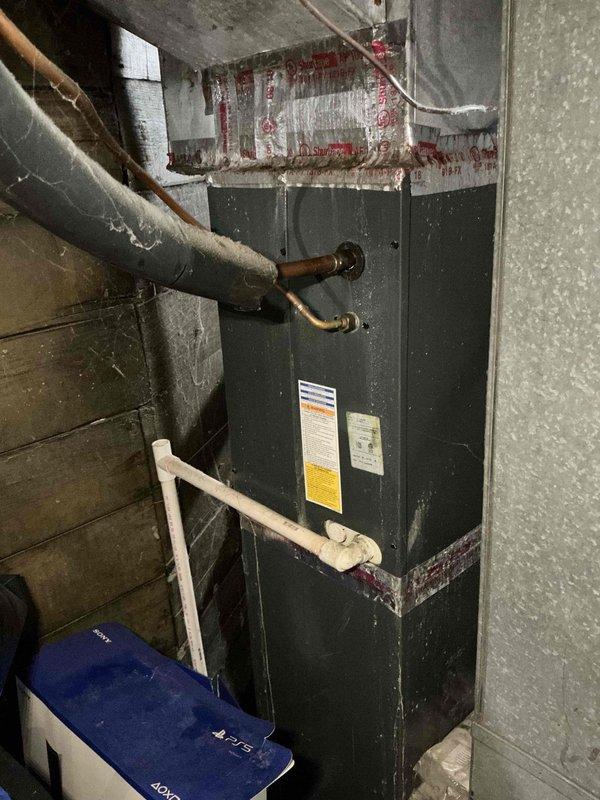Performed seasonal maintenance on a Lennox split system air conditioning unit with indoor air handler located in basement and outdoor condenser positioned on exterior mulch bed. Completed comprehensive inspection of both components, including visual assessment of refrigerant lines, electrical connections, and overall system condition. Verified proper operation of condenser fan motor and compressor, checked refrigerant line insulation integrity, and inspected condensate drainage system at air handler. System age could not be determined from available information. Unit operational upon completion of maintenance service.