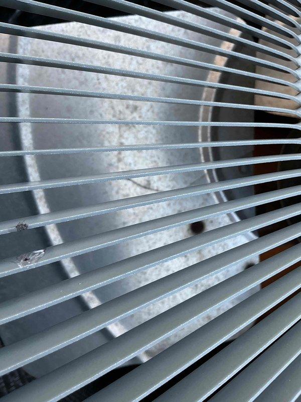 Responded to no cool complaint on 2-year-old air conditioning system that was not reaching thermostat setpoint following previous service visit. Performed diagnostic inspection of outdoor condenser unit, examining condenser coil fins for airflow restrictions and potential efficiency issues. Documented coil condition with photos showing minor dirt accumulation on fins but overall acceptable cleanliness. Evaluated system operation, refrigerant levels, and electrical components to identify root cause of inadequate cooling performance.