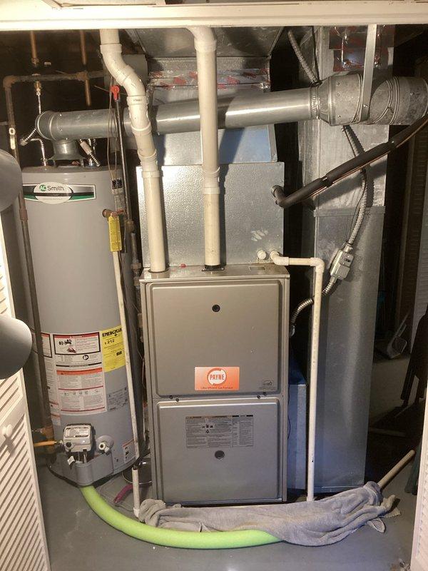 Conducted on-site evaluation of existing HVAC system for replacement estimate. Assessed current Payne gas furnace and outdoor condensing unit, both requiring replacement due to age and efficiency concerns. Documented existing equipment configuration including furnace location in mechanical room, venting arrangement with PVC and metal ductwork, and outdoor condenser positioned on concrete pad against home exterior. Photographed equipment specifications, installation conditions, and access considerations for replacement planning. Provided comprehensive replacement options and recommendations for new high-efficiency heating and cooling system.