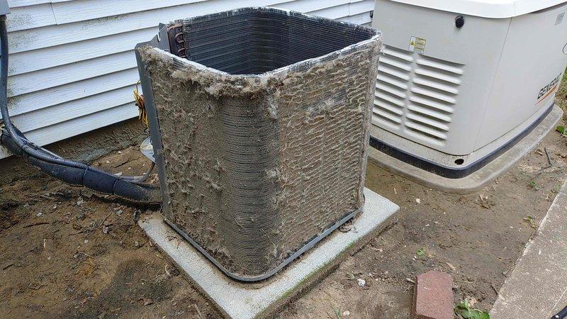 Completed preventive maintenance tune-up on an 8-year-old outdoor air conditioning condenser unit with cylindrical coil design. Unit was heavily soiled with accumulated dirt, dust, and debris requiring thorough cleaning of exterior surfaces and coil fins. Performed comprehensive inspection of refrigerant lines, electrical connections, and mechanical components to ensure optimal system performance and efficiency for the cooling season.