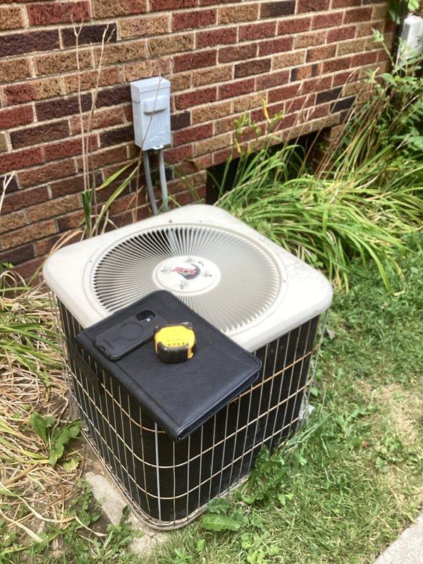 Conducted comprehensive assessment of existing HVAC system for complete replacement of furnace and air conditioning equipment. Evaluated outdoor condenser unit positioned on concrete pad against exterior brick wall, noting current configuration with electrical conduit and disconnect. Inspected indoor furnace unit located in basement utility area, documenting existing ductwork layout, clearances, and connections to distribution system. Photographed both units to document current equipment specifications, installation conditions, and surrounding infrastructure. Provided detailed estimate for complete system replacement including removal of existing equipment, installation of new high-efficiency furnace and air conditioning system, and necessary modifications to electrical service and ductwork connections.