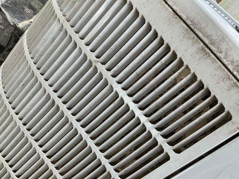 Responded to service call for 11-year-old air conditioning system reported as malfunctioning. Upon arrival, performed visual inspection of outdoor condenser unit and identified dirty condenser coils with accumulated debris and dust restricting airflow. Inspected indoor air handler and found heavily soiled air filter with significant particulate buildup, reducing system efficiency and airflow. Recommended immediate filter replacement and condenser coil cleaning to restore proper operation and prevent compressor strain.