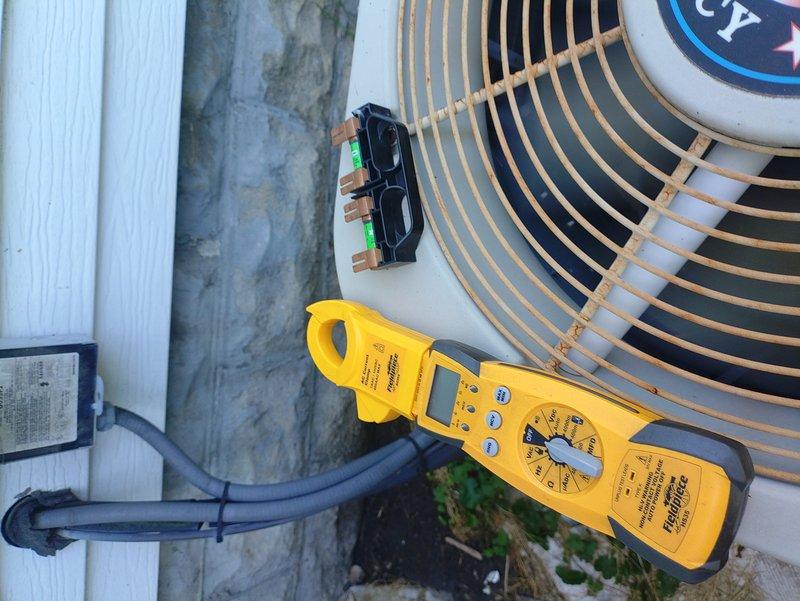 Performed comprehensive air conditioning tune-up service on outdoor condensing unit. Conducted electrical diagnostics using clamp meter to verify proper amperage draw and system performance, inspected refrigerant service valves, and confirmed all components operating within manufacturer specifications.