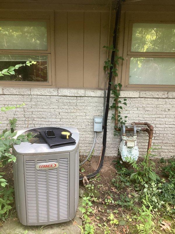 Completed comprehensive estimate for full HVAC system replacement including both furnace and air conditioning unit. Assessed existing outdoor Lennox AC unit mounted against exterior wall with refrigerant lines, electrical disconnect, and gas meter connections, noting established installation with vegetation growth around equipment. Evaluated indoor equipment consisting of stacked white Appliance brand air handler and gray/beige BluFlame furnace unit in mechanical room. Documented current system configuration, photographed all equipment and connections, and provided replacement recommendations for complete heating and cooling system upgrade.