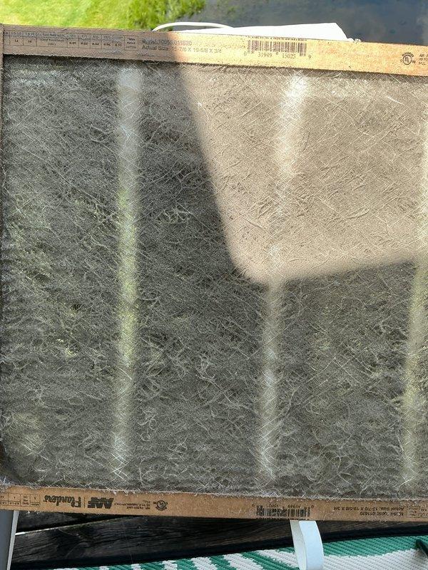 Responded to no cooling complaint on Trane air conditioning system. Upon arrival, found return air filter completely blocked with heavy dust and debris accumulation, severely restricting airflow to the system. Removed and replaced extremely dirty filter with new filter, restoring proper airflow to the evaporator coil. System operational and cooling properly after filter replacement; no refrigerant charge issues found as proper airflow was the root cause of cooling deficiency.