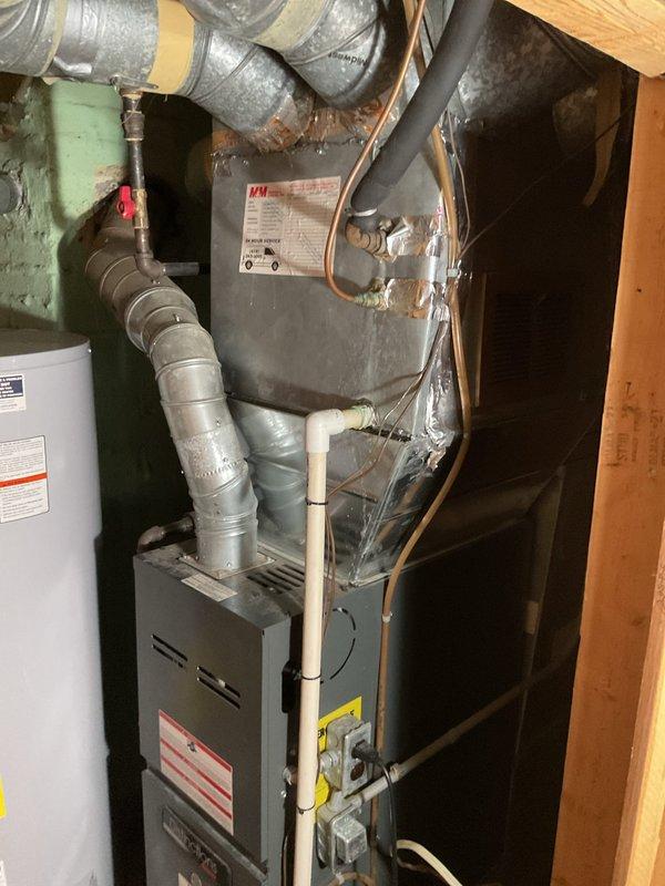 Conducted comprehensive assessment of existing residential HVAC system for air conditioning replacement. Evaluated current outdoor condensing unit showing signs of weathering and corrosion, along with interior furnace and mechanical components in utility closet. Documented existing equipment configuration including ductwork connections, refrigerant lines, electrical service, and clearance conditions to provide accurate replacement estimate and equipment specifications.