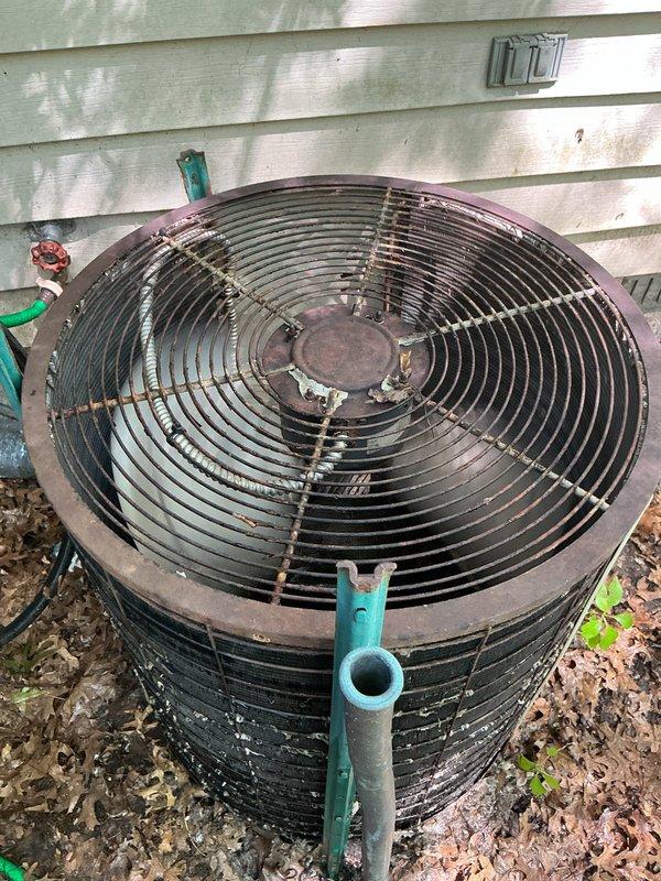 Responded to no cooling complaint on residential air conditioning system. Upon arrival, found outdoor condenser unit with significant debris accumulation around base and evidence of extended outdoor exposure with visible weathering on cabinet. Performed visual inspection of unit exterior, documented condition of condenser housing showing rust and discoloration, and verified electrical connections and refrigerant line connections at service valves. Assessed unit's operational status and overall system condition to determine root cause of cooling failure.