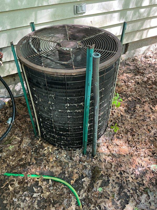 Responded to no cooling complaint on residential air conditioning system. Upon arrival, found outdoor condenser unit with significant debris accumulation around base and evidence of extended outdoor exposure with visible weathering on cabinet. Performed visual inspection of unit exterior, documented condition of condenser housing showing rust and discoloration, and verified electrical connections and refrigerant line connections at service valves. Assessed unit's operational status and overall system condition to determine root cause of cooling failure.