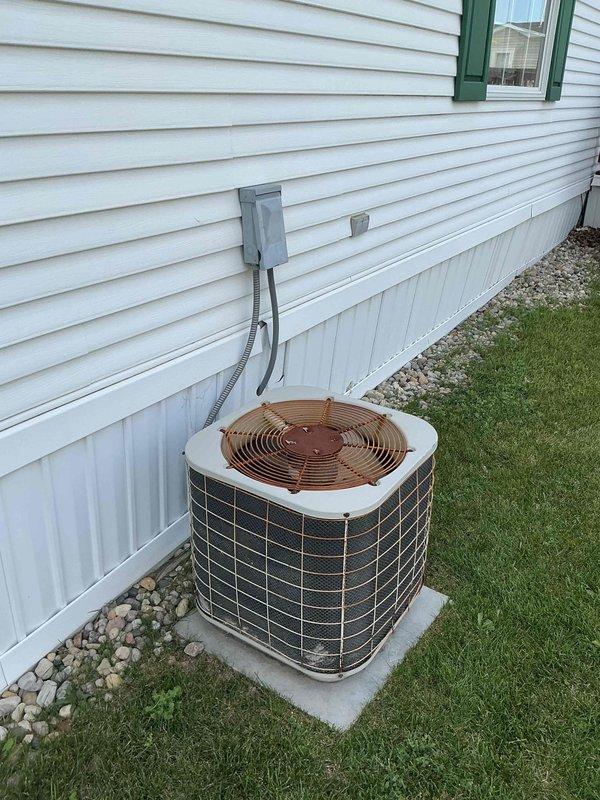 Completed comprehensive AC tune-up on outdoor condensing unit with system operating within normal parameters. Performed standard maintenance protocol including inspection of electrical components, capacitor, and contactor, verified proper operation of compressor and fan motor, and confirmed adequate airflow through condenser coil. Unit showing age-related cosmetic wear but all mechanical and electrical systems functioning properly with no immediate service needs identified.