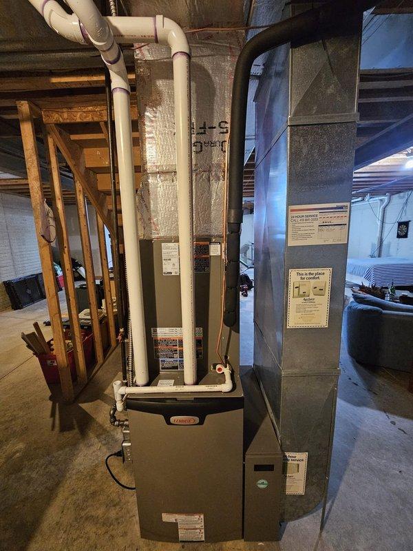 Completed full HVAC system installation in residential basement, including Lennox Elite Series 97% efficiency upflow furnace with upflow cased coil, 18 SEER condensing unit, and S-40 thermostat. Installed 50 feet of new refrigerant lineset, metal condensate pump with tubing, 5-inch filter rack, new outdoor pad, and electrical disconnect with whip. All ductwork properly connected with foil-faced insulation, equipment mounted per manufacturer specifications, and system tested for proper operation. Furnace and air handler positioned for optimal air circulation throughout the home, with PVC venting routed through basement ceiling and all electrical connections completed to code.