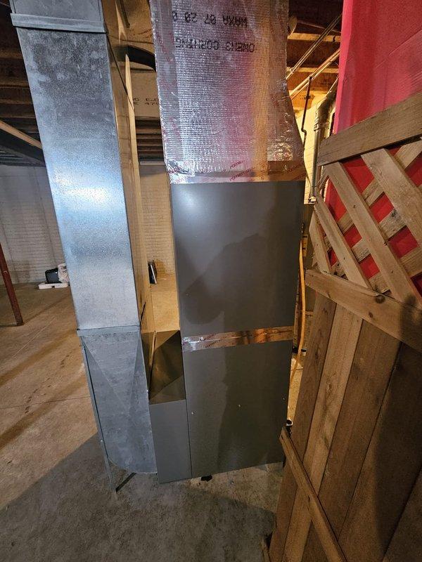 Completed full HVAC system installation in residential basement, including Lennox Elite Series 97% efficiency upflow furnace with upflow cased coil, 18 SEER condensing unit, and S-40 thermostat. Installed 50 feet of new refrigerant lineset, metal condensate pump with tubing, 5-inch filter rack, new outdoor pad, and electrical disconnect with whip. All ductwork properly connected with foil-faced insulation, equipment mounted per manufacturer specifications, and system tested for proper operation. Furnace and air handler positioned for optimal air circulation throughout the home, with PVC venting routed through basement ceiling and all electrical connections completed to code.