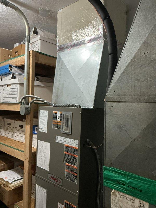 Completed full HVAC system installation in mechanical room consisting of new Lennox heat pump and upflow air handler. Installed air handler on existing base with new heat strips for supplemental heating. Ran new refrigerant line set with proper insulation and flushed lines to ensure system integrity. Relocated outdoor heat pump unit approximately three feet from meter on new equipment pad with pump-up blocks for proper drainage and clearance. Installed new metallic ductwork with reflective insulation to connect air handler to existing distribution system. Ran new electrical disconnect and whip for code-compliant power supply to outdoor unit. Mounted and wired new thermostat for system control. Tested all electrical connections, verified proper refrigerant charge, and confirmed heating and cooling operation across all system components.