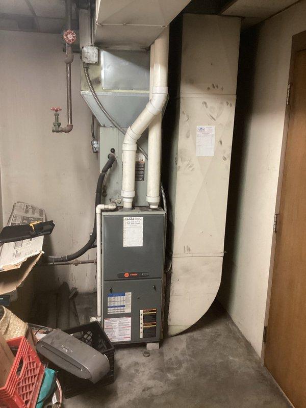 Completed comprehensive equipment estimate for full commercial HVAC system replacement, evaluating existing residential-grade furnace in basement utility area and outdoor condenser units. Documented current system configuration including gray metal furnace with PVC exhaust venting, black flexible ductwork, and dual outdoor units positioned on concrete pavers against building exterior. Coordinated with management regarding previous repair work and confirmed availability of parts credit toward new installation.