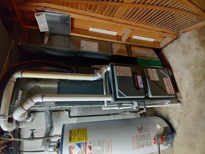 Completed preventive maintenance on an 8-year-old residential air conditioning system. Inspected outdoor condenser unit located on concrete pad adjacent to deck, verified proper airflow through louvers and cleaned debris from unit exterior. Performed indoor inspection of air handler and associated ductwork in basement utility area, checked refrigerant lines, electrical connections, and confirmed system operational status for cooling season.