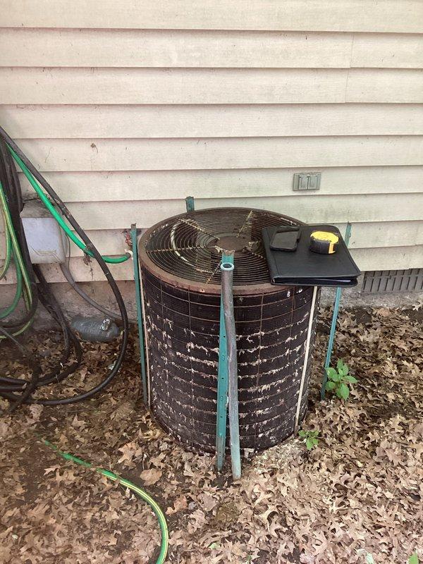 Conducted comprehensive assessment of existing residential air conditioning system for complete replacement. Evaluated outdoor condenser unit showing significant age-related deterioration, accumulated debris on metal fins, and overall wear requiring full system replacement. Inspected indoor ductwork configuration and air handling components in basement utility area. Documented current equipment conditions including galvanized ductwork, insulation installation, and existing HVAC unit specifications. Provided detailed replacement estimate for new complete air conditioning system installation.
