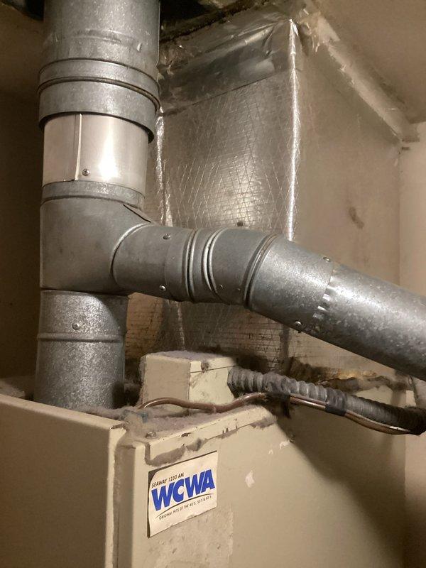 Conducted comprehensive assessment of existing residential air conditioning system for complete replacement. Evaluated outdoor condenser unit showing significant age-related deterioration, accumulated debris on metal fins, and overall wear requiring full system replacement. Inspected indoor ductwork configuration and air handling components in basement utility area. Documented current equipment conditions including galvanized ductwork, insulation installation, and existing HVAC unit specifications. Provided detailed replacement estimate for new complete air conditioning system installation.