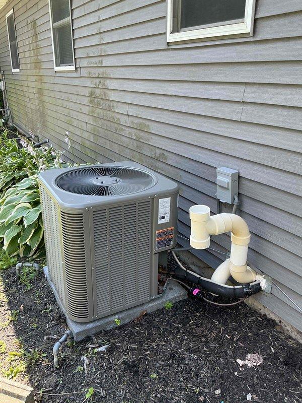 Completed routine maintenance on residential split-system air conditioning unit, including inspection of Amana furnace and air handler located in basement utility area and exterior condensing unit. Performed thorough cleaning of all accessible components, verified proper operation of system controls and thermostat, checked refrigerant levels, inspected electrical connections at disconnect box, and confirmed adequate condensate drainage through PVC piping system. All equipment found to be operating within normal parameters, and photographic documentation was captured of both indoor and outdoor components for service records.