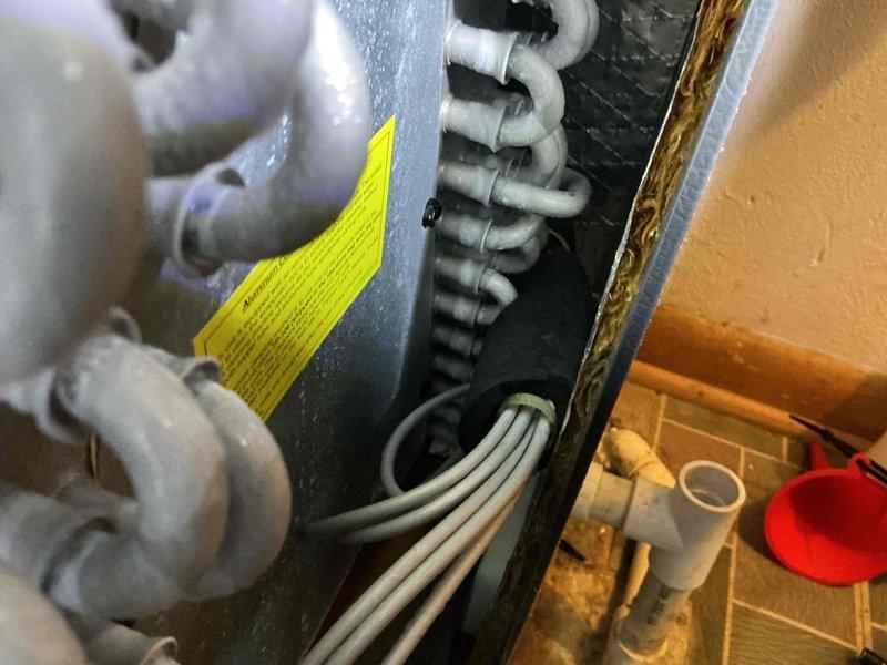 Performed annual maintenance on 6-year-old split system air conditioning unit. Inspected indoor air handler, refrigerant lines, and heat exchanger coil assembly; verified all components operating within normal parameters with no issues detected. Documented equipment condition with photos showing clean heat exchanger tubing and properly connected refrigerant lines.