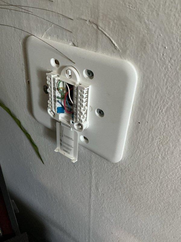 Responded to service call for malfunctioning Honeywell Home ProSeries thermostat connected to a one-year-old AC system. Upon arrival, verified thermostat was displaying erratic behavior with no error messages or blank screen conditions. Removed thermostat faceplate and inspected all wiring connections at terminal block, confirming proper wire placement including R, C, Y, G, and W terminals. Performed system reset by removing thermostat from wall plate, cycling power at breaker, and reinstalling unit. Verified all colored wires were securely seated in appropriate terminals with no loose connections. Tested thermostat functionality through multiple cooling cycles to ensure proper communication with AC unit. System restored to normal operation with accurate temperature readings and responsive controls.