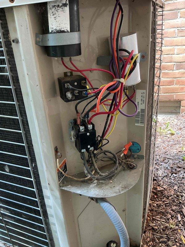 Performed preventative maintenance tune-up on 15-year-old residential air conditioning system. Inspected outdoor condensing unit electrical components including capacitor, contactors, and wiring connections; verified proper operation and cleaned accessible surfaces. Evaluated indoor evaporator coil condition and refrigerant lines, noting oxidation on copper piping consistent with system age. All components found operational with system performing within normal parameters for unit age.