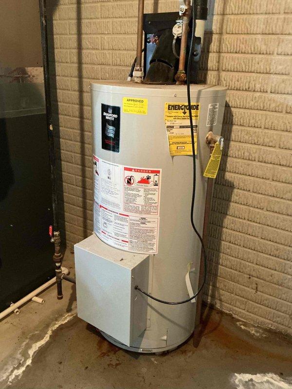 Responded to service call for aging water heater with active leak. Upon arrival, performed thorough assessment of existing Bradford White tank-style water heater unit installed in basement utility area. Confirmed visible signs of water damage on concrete floor surrounding base of unit, indicating active leak from tank. Evaluated overall condition of water heater, noting age-related deterioration and compromised tank integrity beyond economical repair.

Documented existing installation configuration, including copper supply line connections, shut-off valve locations, and current venting system. Photographed unit specifications, warning labels, and energy guide information for reference. Assessed proper clearances, base platform condition, and surrounding plumbing infrastructure. Reviewed electrical and gas connections to determine compatibility requirements for replacement unit.

Provided customer with professional estimate for complete water heater replacement, including removal and di