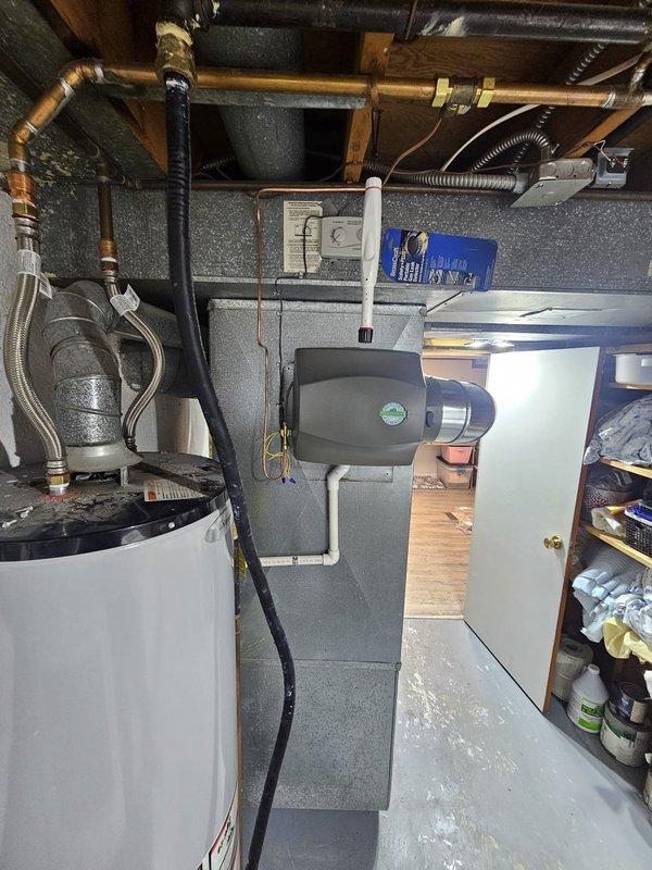 Completed full HVAC system installation including an 80% efficiency upflow furnace with matched upflow cased evaporator coil in the basement utility area. Installed new refrigerant lineset connecting the indoor and outdoor units, along with a single-stage air conditioning condenser positioned on a new concrete equipment pad against the exterior of the home. Added a 12-gallon bypass humidifier to the ductwork for whole-home humidity control. Installed new electrical disconnect and whip for code-compliant condenser power supply. Upgraded the system controls with a WiFi-enabled thermostat for remote monitoring and temperature management. All equipment was properly positioned, leveled, and secured according to manufacturer specifications and local building codes. System was pressure tested, evacuated, charged to factory specifications, and cycled through multiple heating and cooling operations to verify proper performance of all components.