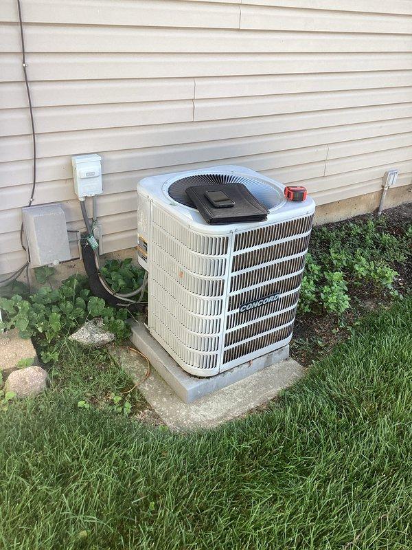Conducted on-site assessment for complete air conditioning system replacement at residential property. Evaluated existing outdoor condenser unit and indoor furnace system to determine compatibility requirements and proper sizing for new AC installation. Documented current equipment configuration including Concord furnace with PVC venting system, existing ductwork connections, and outdoor condenser unit positioned on concrete pad with electrical disconnect. Provided comprehensive replacement estimate covering removal of existing AC system and installation of new energy-efficient air conditioning equipment with appropriate refrigerant lines, electrical connections, and integration with existing forced-air heating system.