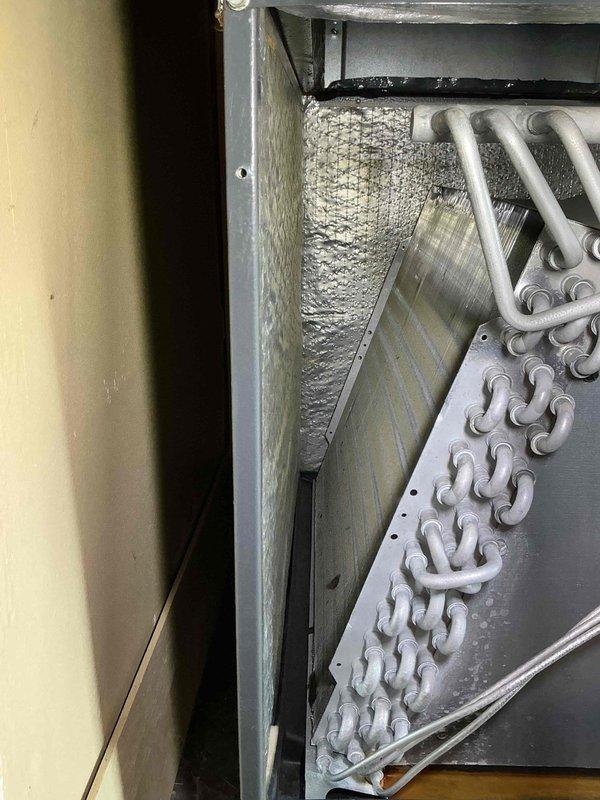 Completed preventive maintenance tune-up on 13-year-old residential air conditioning system. Performed standard inspection of heat exchanger coils, evaporator assembly, and air handler components; all internal components found to be in operational condition with normal wear for unit age.