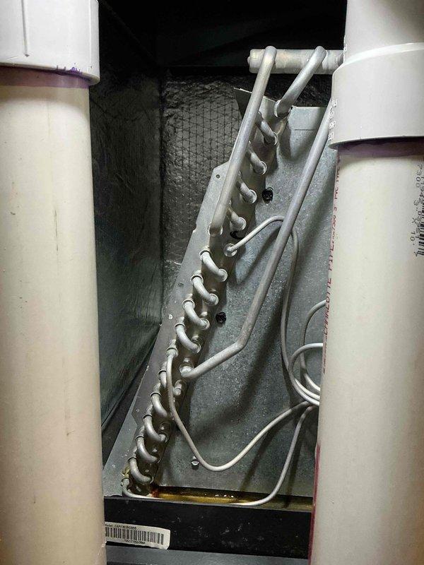 Completed routine maintenance on 7-year-old cooling system during scheduled service window. Inspected evaporator coil assembly, verified proper refrigerant line routing and insulation integrity, and documented system condition through photographic documentation. All components operating within normal parameters with no immediate service needs identified.