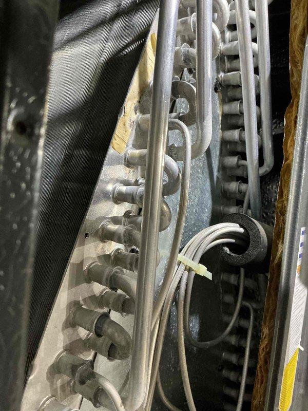 Completed comprehensive AC tune-up on a 4-year-old cooling system. Performed thorough inspection of evaporator coil assembly, verified proper refrigerant flow through heat exchanger coils, and assessed overall system operation. All components found to be functioning within normal parameters with minor dust accumulation noted on coil surfaces.