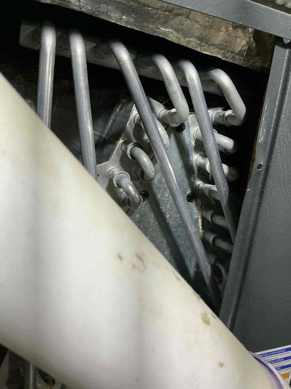 Completed comprehensive AC tune-up on a 4-year-old cooling system. Performed thorough inspection of evaporator coil assembly, verified proper refrigerant flow through heat exchanger coils, and assessed overall system operation. All components found to be functioning within normal parameters with minor dust accumulation noted on coil surfaces.