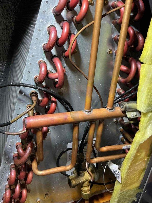 Completed scheduled maintenance on 11-year-old air conditioning system. Inspected evaporator coil and refrigerant lines, verified proper operation of all components including copper piping connections, brass fittings, and insulation integrity. System operating within normal parameters with all safety checks passed.