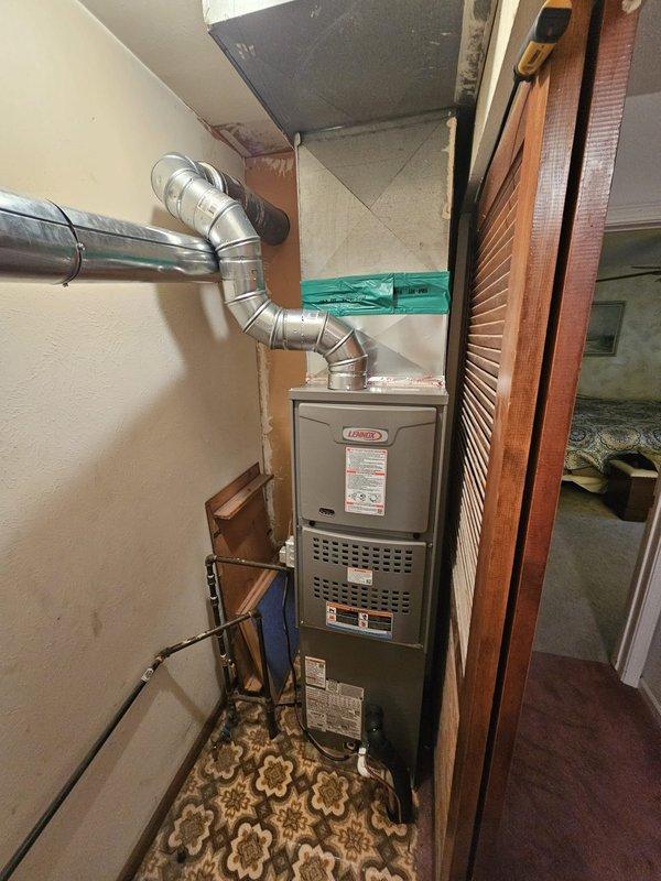 Completed full HVAC system replacement including installation of a downflow 80% efficiency 90,000 BTU furnace with matching downflow cased evaporator coil. Installed new single-stage outdoor condensing unit on concrete equipment pad with new disconnect box and electrical whip. Ran new 3/4-inch refrigerant line set spanning 50 feet to connect outdoor and indoor components. Configured supply ductwork with metallic transitions to accommodate downflow furnace orientation. Installed new thermostat and verified system operation across heating and cooling modes.
