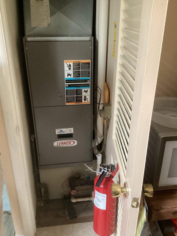 Completed comprehensive assessment of existing Lennox furnace and air conditioning system located in interior utility closet. Evaluated current HVAC equipment condition, ductwork configuration, electrical connections, and available clearances for replacement installation. Documented existing vertical furnace setup with curved plenum transition, measured equipment dimensions and spatial constraints within confined closet area. Photographed manufacturer labels, safety warnings, and technical specifications for reference. Provided detailed estimate for complete furnace and AC system replacement including equipment removal, new unit installation, and necessary modifications to accommodate updated HVAC components.