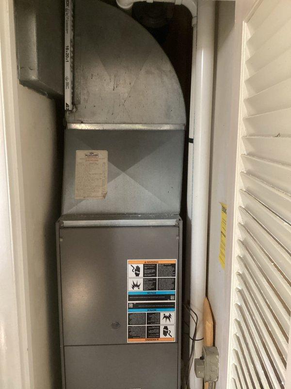 Completed comprehensive assessment of existing Lennox furnace and air conditioning system located in interior utility closet. Evaluated current HVAC equipment condition, ductwork configuration, electrical connections, and available clearances for replacement installation. Documented existing vertical furnace setup with curved plenum transition, measured equipment dimensions and spatial constraints within confined closet area. Photographed manufacturer labels, safety warnings, and technical specifications for reference. Provided detailed estimate for complete furnace and AC system replacement including equipment removal, new unit installation, and necessary modifications to accommodate updated HVAC components.