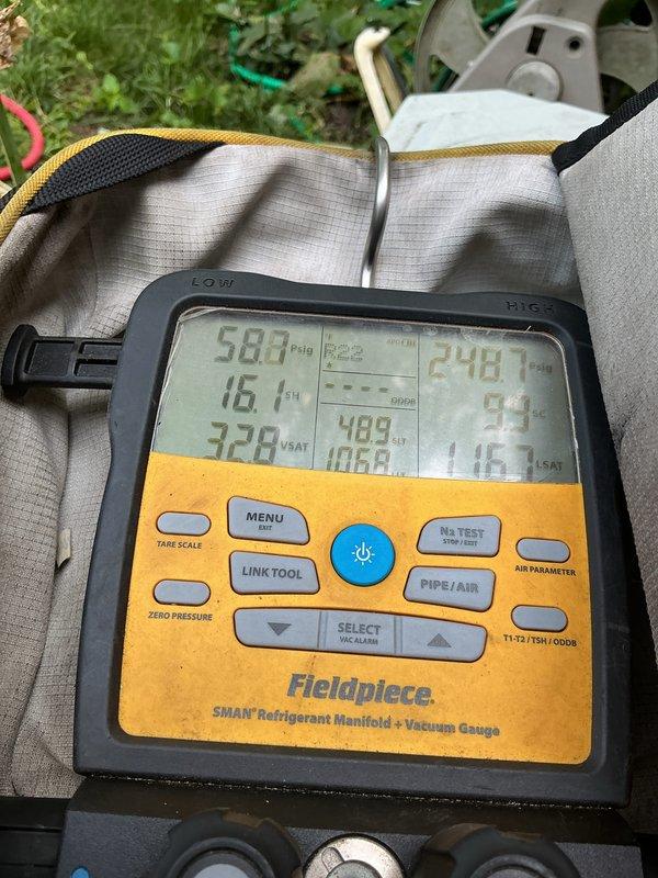 Completed annual cooling maintenance on 24-year-old Trane air conditioning system. Performed comprehensive tune-up including refrigerant pressure and superheat measurements using digital manifold gauges, verifying system charge and operational parameters were within manufacturer specifications. Inspected outdoor condensing unit mounted on exterior brick wall, noting age-related weathering on electrical disconnect box but confirmed all components functioning properly for continued seasonal operation.