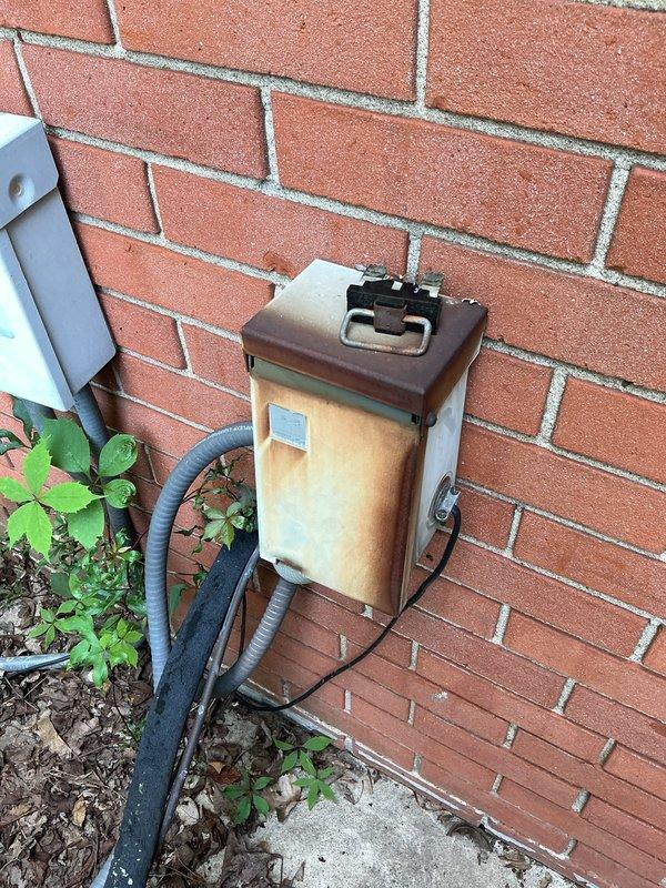 Completed annual cooling maintenance on 24-year-old Trane air conditioning system. Performed comprehensive tune-up including refrigerant pressure and superheat measurements using digital manifold gauges, verifying system charge and operational parameters were within manufacturer specifications. Inspected outdoor condensing unit mounted on exterior brick wall, noting age-related weathering on electrical disconnect box but confirmed all components functioning properly for continued seasonal operation.