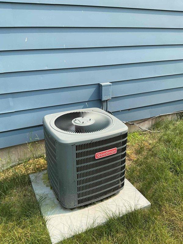 Completed maintenance tune-up on 4-year-old Goodman ground-level condenser unit. Performed standard preventative maintenance procedures including inspection of electrical components, capacitor testing, and system operational check. Customer reported home temperature reaching 80 degrees with insufficient airflow through supply and return vents; diagnostic assessment revealed undersized air conditioning system for square footage of residence. Pressure readings indicated 300 CFM at all supply vents except one register measuring 1700 CFM, suggesting possible ductwork restriction or damper imbalance. Inspected condenser coil, fan motor operation, and refrigerant lines during service visit. Accessed internal components through side panel to verify electrical connections and capacitor function. Recommended system evaluation for potential replacement due to inadequate cooling capacity for home size and airflow distribution issues requiring further investigation of duct system design and sizing