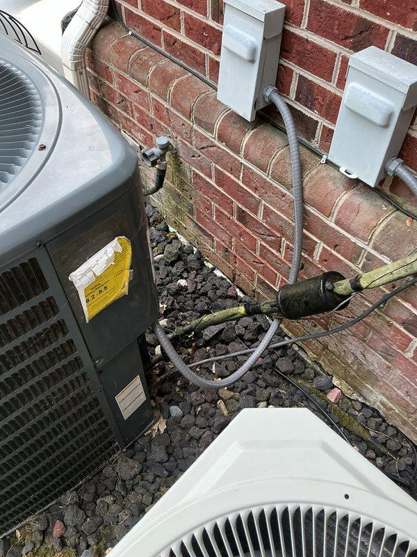Responded to no cooling call on 35-year-old attic-mounted air conditioning system. Accessed attic unit via ladder and performed comprehensive diagnostic evaluation of the aging HVAC equipment. Upon inspection, determined system had reached end of serviceable life due to age and component deterioration. Documented existing outdoor condenser units and electrical connections showing typical wear patterns consistent with three-and-a-half decades of operation, including weathered conduit, aged junction boxes, and compromised insulation materials around equipment pad area.