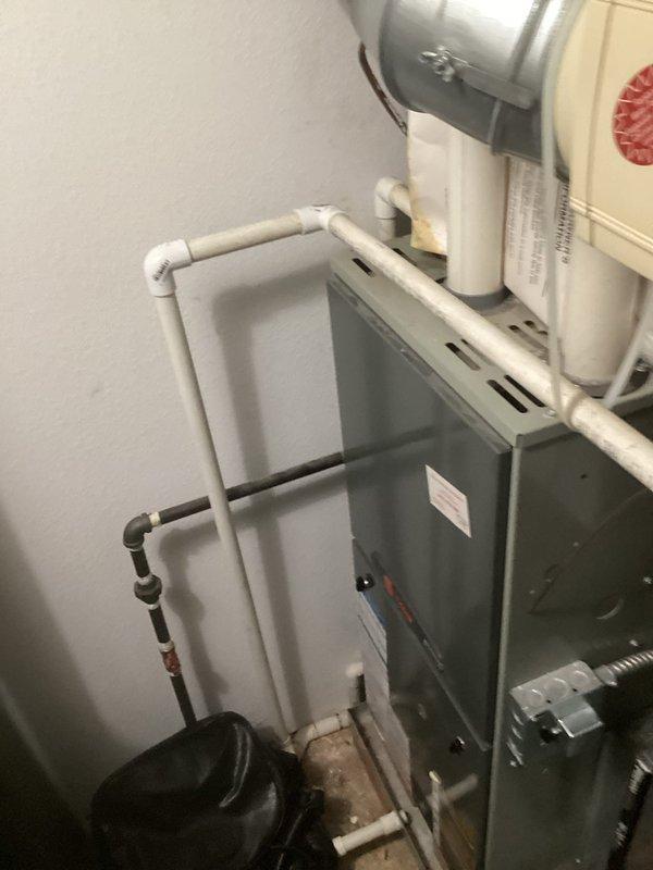 Conducted comprehensive on-site evaluation of existing HVAC system including two air conditioning units and furnace installation in mechanical room. Documented current equipment configuration, ductwork layout, condensate drainage system, and ventilation components through detailed photography. Assessed furnace condition, air handler placement, PVC piping network, and metallic ductwork connections to provide accurate replacement recommendations and specifications for complete system upgrade.