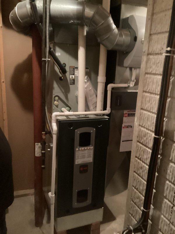 Conducted comprehensive on-site evaluation of existing HVAC system including two air conditioning units and furnace installation in mechanical room. Documented current equipment configuration, ductwork layout, condensate drainage system, and ventilation components through detailed photography. Assessed furnace condition, air handler placement, PVC piping network, and metallic ductwork connections to provide accurate replacement recommendations and specifications for complete system upgrade.