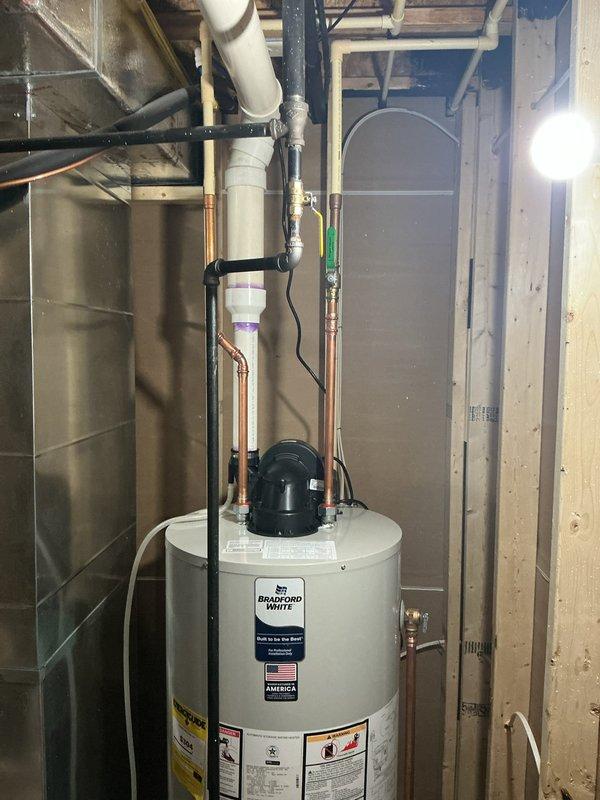 Responded to emergency service call for Bradford White tank water heater experiencing recurring leak from top connections, which had caused approximately 2 inches of standing water accumulation in finished basement area. Upon arrival, inspected all top-mounted connections, piping, and fittings; identified source of leak at improperly sealed connection point. Tightened and resealed affected connections, verified proper alignment of unit using level to ensure no stress on piping, and conducted pressure test to confirm leak was fully resolved with no further water discharge detected.