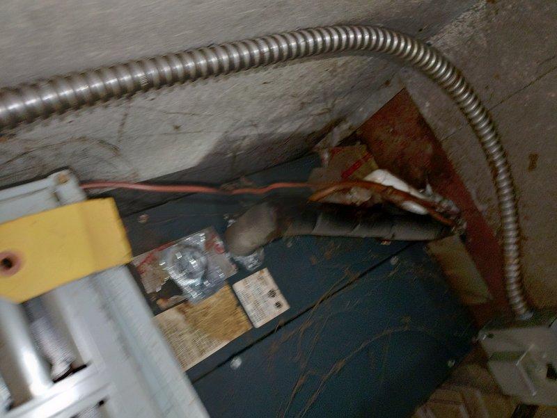 Responded to service call for noisy blower motor on aging furnace system estimated at over 20 years old. Upon inspection, identified worn blower fan bearings as source of operational noise. Documented existing equipment condition with photos showing motor assembly with visible wear, paint deterioration, and flexible conduit connections, as well as internal cabinet components including ductwork and evaporator coil assembly. Customer advised of findings and equipment age considerations for future planning.