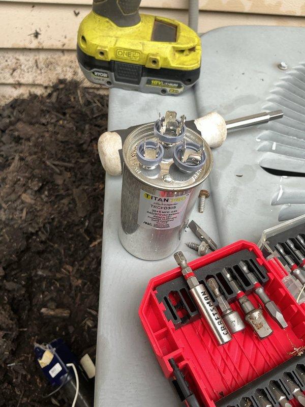 Responded to service call for air conditioning system cooling intermittently and failing to maintain thermostat temperature setpoint with "call for service" error message displayed. Upon inspection, diagnosed failed run capacitor causing compressor to short cycle and operate inefficiently. Replaced defective capacitor with new TITAN dual-run capacitor, verified proper electrical connections, and tested system operation. Unit now cooling properly with thermostat maintaining temperature setpoint and error message cleared.
